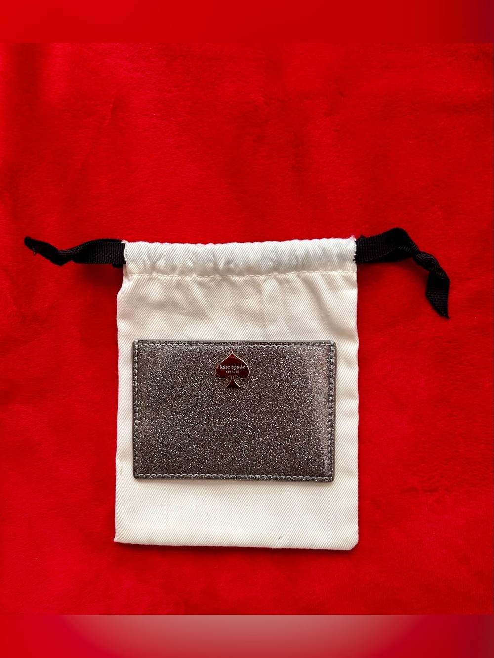 Kate Spade glitter card holder in a silver